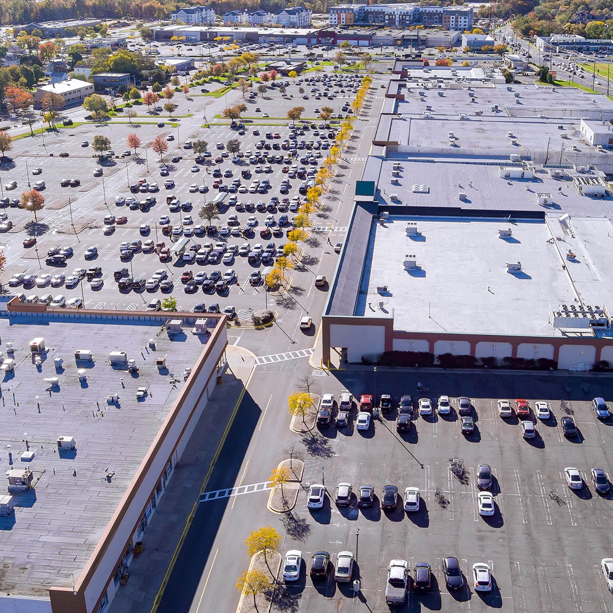 There is a large parking lot with cars near shopping mall center in New Jersey, United States